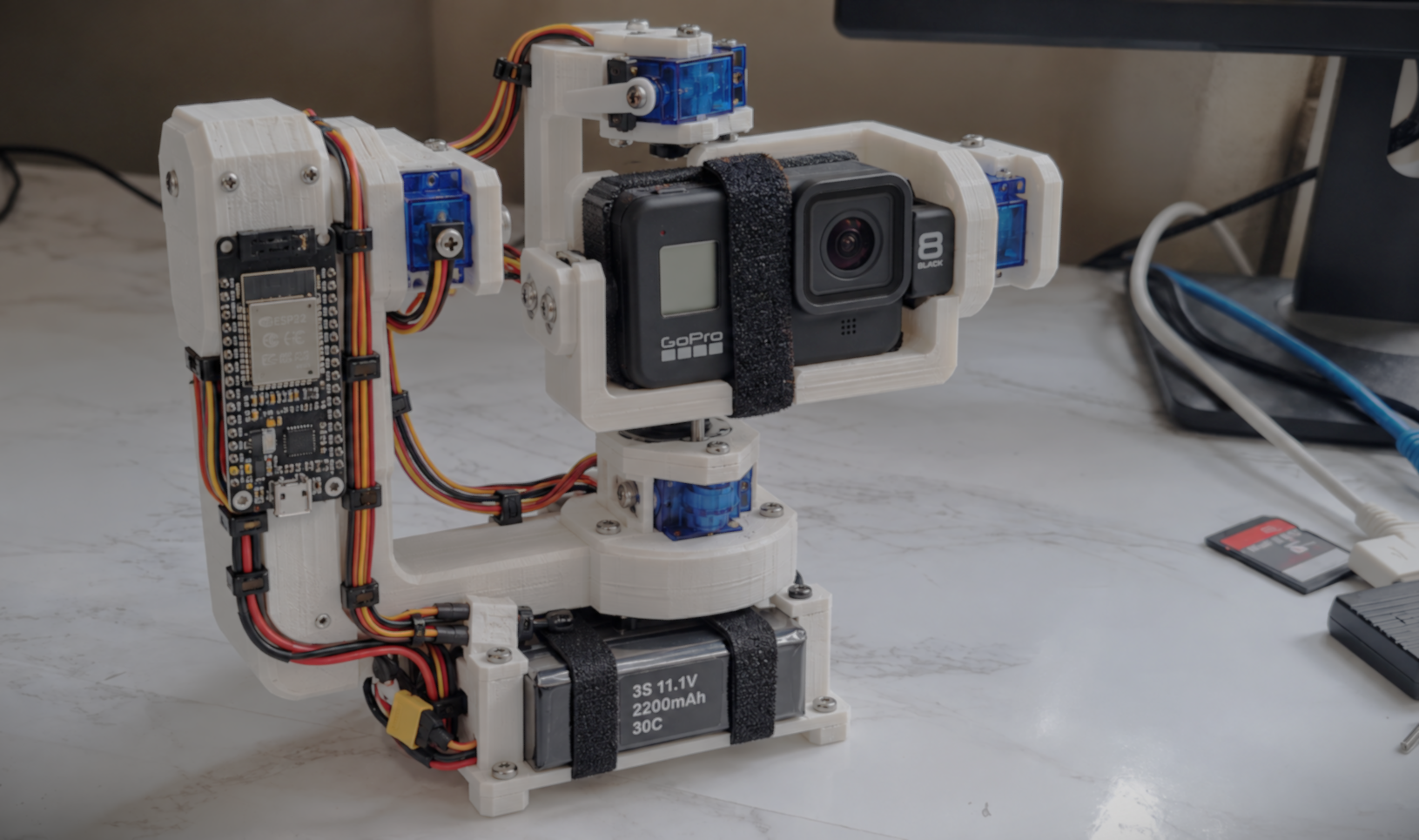 Printed camera gimbal with a mounted GoPro, servos, wiring and microcontroller