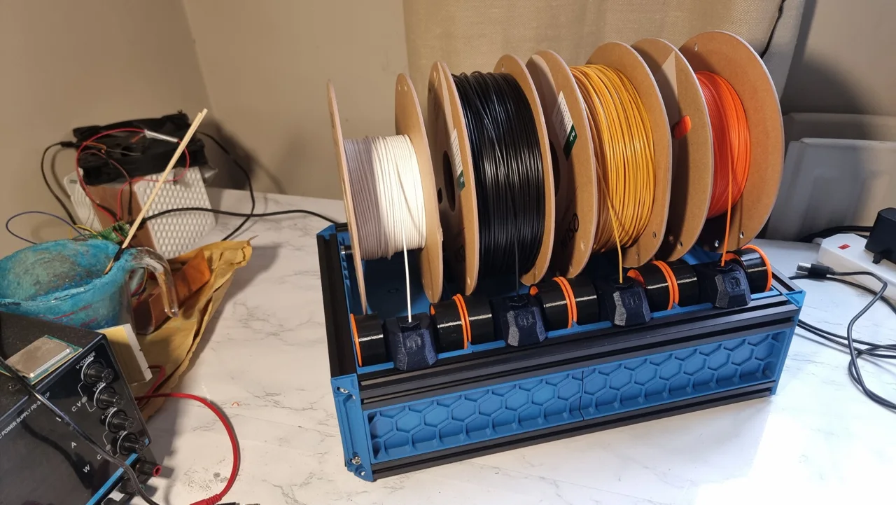 The BoxTurtle filament system with four spools and printed feed components